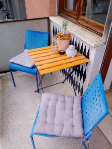 a wooden table and two chairs on a porch at Le stanze di Bruno in Pescara