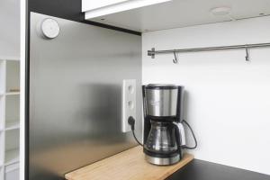 a blender sitting on a wooden shelf in a kitchen at Stunning Bright Duplex in Saint-Ouen