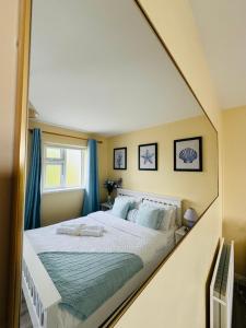 a bedroom with a large bed with blue curtains at Erris Ocean House in Belmullet