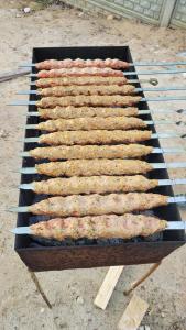 a grill with a bunch of meat on it at EmiLiza in Kobuleti