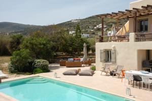 a villa with a swimming pool and a house at Parasporos Villa - Private Pool - Beach Access in Parasporos