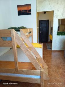 a large wooden bunk bed in a room at Studioul vacanțelor din Saturn 2 in Saturn