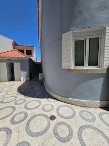 a building with a window and a tiled floor at SAN PEDRO Beach House in Estoril +19 photos