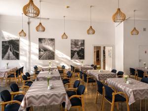 a row of tables and chairs in a room at Hotel Karolinka in Karpacz