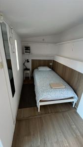 a bedroom with a bed in a small room at SAN PEDRO Beach House in Estoril