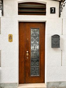 a wooden door on a white building with a number at Rainbow District Mood Villa in Milan