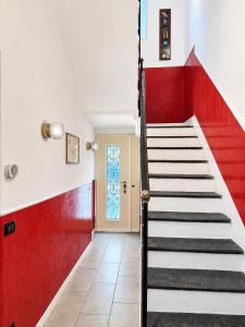 a staircase in a house with red and white walls at Rainbow District Mood Villa in Milan