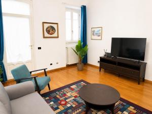 a living room with a couch and a table at Rainbow District Mood Villa in Milan