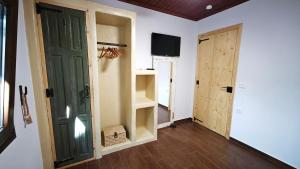 a room with a door and a room with a tv at LavenderFarmhouse 2 in Nafpaktos