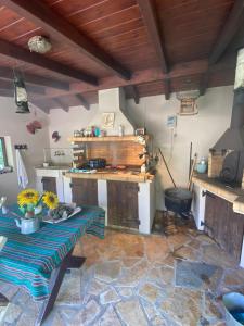a kitchen with a counter and a table with flowers on it at LavenderFarmhouse 2 in Nafpaktos