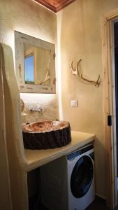 a bathroom with a sink with a mirror and a washing machine at LavenderFarmhouse 2 in Nafpaktos +38 photos