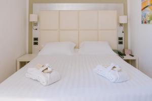 two towels are sitting on a white bed at Grand Hotel Telese in Telese