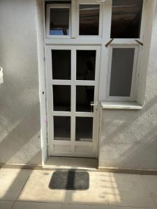 a white door with a window on a building at Hide Avenue Dedinje in Dedinje