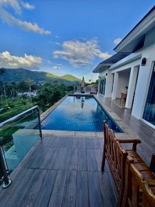 a swimming pool on a wooden deck with a view at Keya Mountain View Pool Villa Samui in Ban Thung