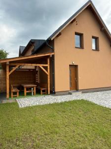 a house with a picnic table in front of it at Apartmány u Anety in Mladé Buky