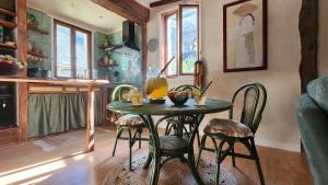 a kitchen with a table and chairs in a room at Appartement in Craon