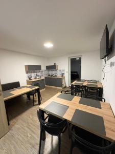 a classroom with tables and chairs in a room at Apartmány u Anety in Mladé Buky