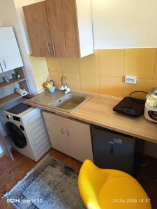 a small kitchen with a sink and a microwave at Studioul vacanțelor din Saturn 2 in Saturn