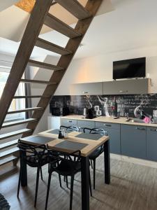 a kitchen with a table and chairs in a room at Apartmány u Anety in Mladé Buky