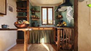 a kitchen with a bowl of fruit on a counter at Appartement in Craon