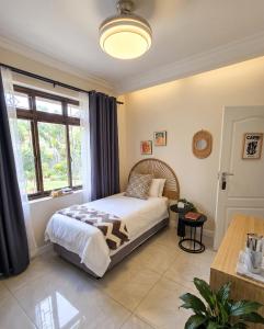 a bedroom with a bed and a large window at Moxley Manor in Durban