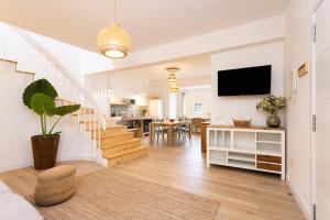 a living room with a television and a dining room at El Valle apartment centro Orotava in La Orotava +25 photos