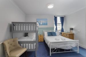 a bedroom with two bunk beds and a chair at Hotel Santa Maria in Blackpool +78 photos