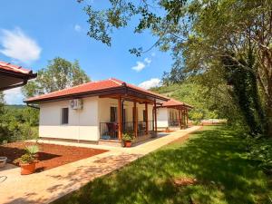 a small house with a green lawn in front of it at Captain's Oasis in Budva +16 photos