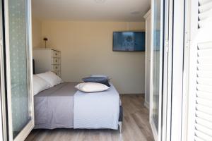 a bedroom with a bed with two pillows on it at Domus Home Ladispoli in Ladispoli