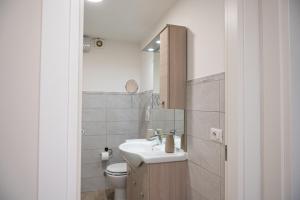 a bathroom with a sink and a toilet at Domus Home Ladispoli in Ladispoli