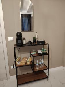 a shelf with food and drinks on it in a room at Domus Mater in Vigonza