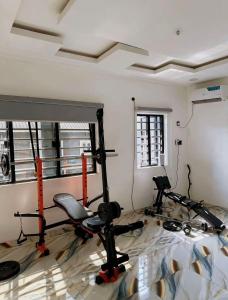 a room with a gym with two tread machines at North Unit in Asaba