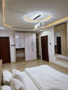 a bedroom with a large bed and white cabinets at North Unit in Asaba