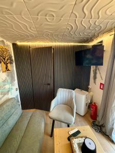 a living room with a chair and a table at AZURA one in Varna City
