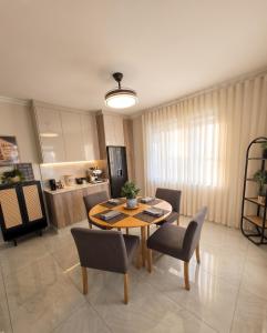 a kitchen and dining room with a table and chairs at Moxley Manor in Durban +9 photos