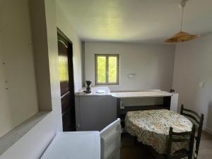 a room with a table and a bed and a window at Appartement indépendant dans maison en pierre in Coeuvres-et-Valsery