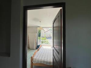 a doorway to a room with a bed and a window at Appartement indépendant dans maison en pierre in Coeuvres-et-Valsery +4 photos