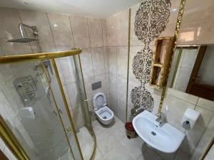 a bathroom with a toilet and a sink and a shower at Osmanlı Suite in Uzungöl +20 photos