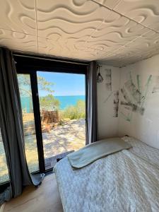 a bedroom with a bed and a view of the ocean at AZURA one in Varna City