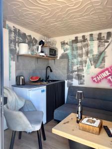 a living room with a table and a kitchen at AZURA one in Varna City