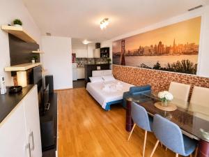 a living room with a bed and a table at Coralia Luna Park Apartments in Mamaia
