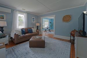 a living room with a couch and a table at Beautiful Modern Beach House! in Old Orchard Beach