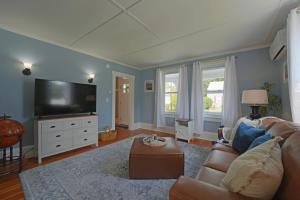 a living room with a couch and a flat screen tv at Beautiful Modern Beach House! in Old Orchard Beach