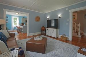 a living room with a couch and a flat screen tv at Beautiful Modern Beach House! in Old Orchard Beach