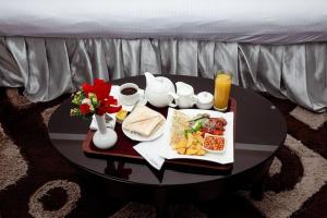 a black table with a tray of food on it at Novatel Radisson Lekki in Lekki