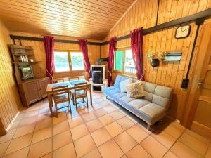 a living room with a couch and a table at Jagdhütte in Zöllnitz