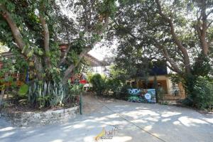a house with trees and plants in front of it at Mount Magica - Refined By Nature in Rānchī