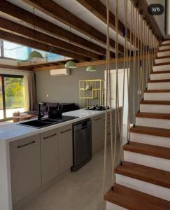 a kitchen with a stove and a staircase at Villa Han Selimiye in Selimiye