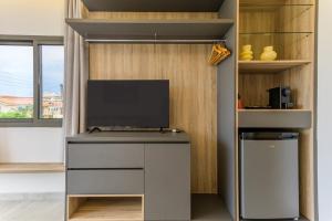 a room with a desk with a television on it at Cavella Apart Hotel in Monsef in Al Ḩulwah