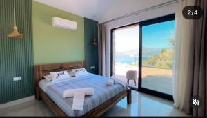 a bedroom with a bed with a large window at Villa Han Selimiye in Selimiye +43 photos